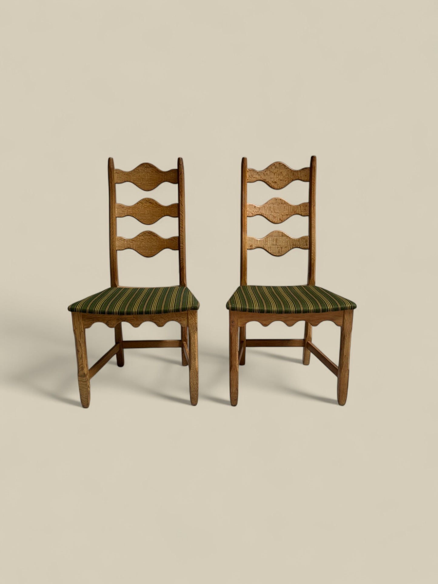 Pair of Henning Kjaernulf green uphosltery dining chairs