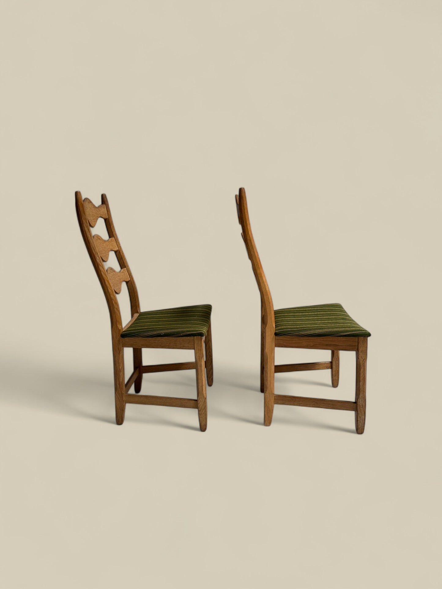 Pair of Henning Kjaernulf green uphosltery dining chairs