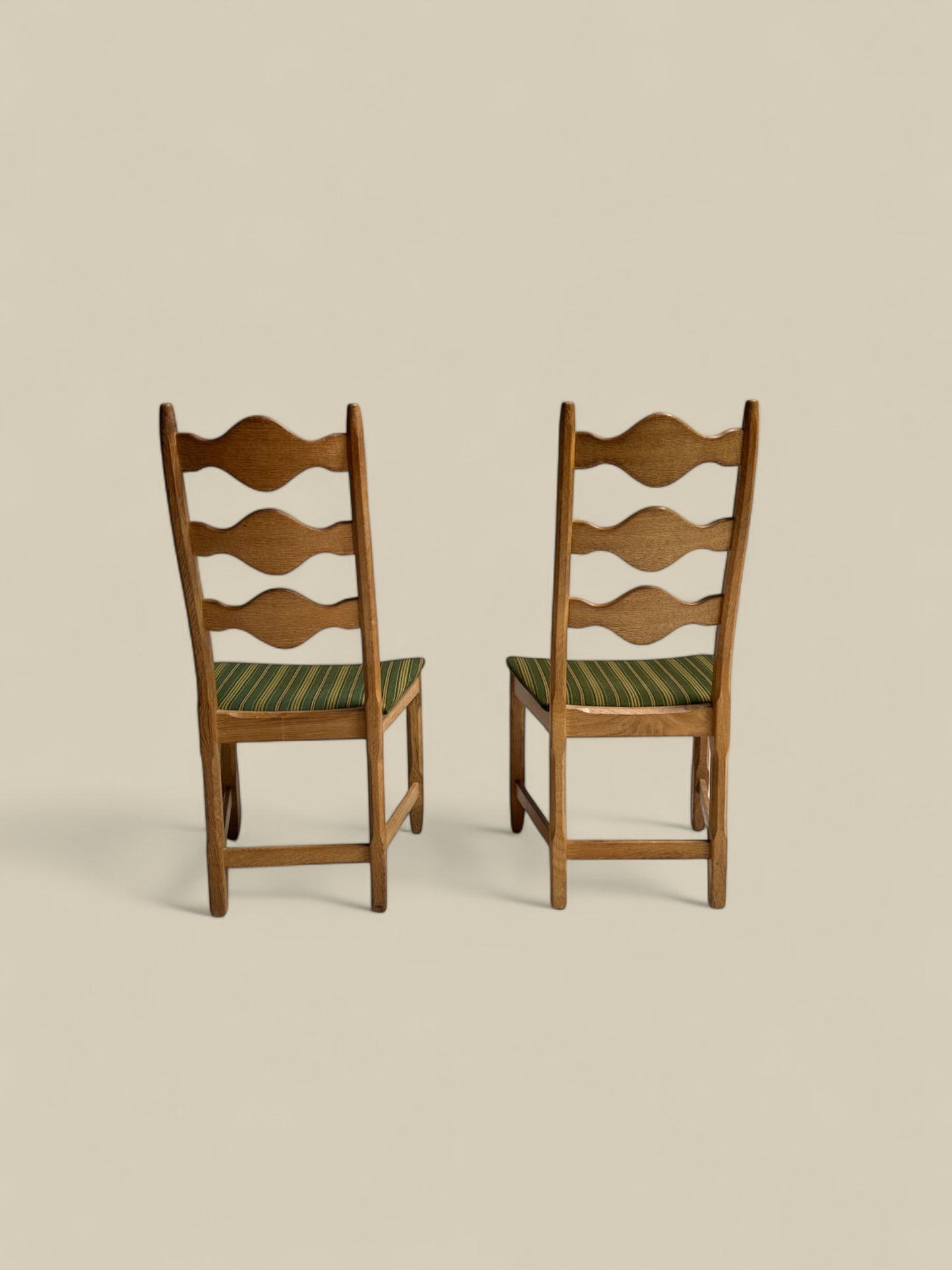 Pair of Henning Kjaernulf green uphosltery dining chairs